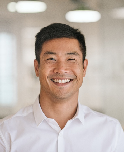 Man in white button-up shirt smiling